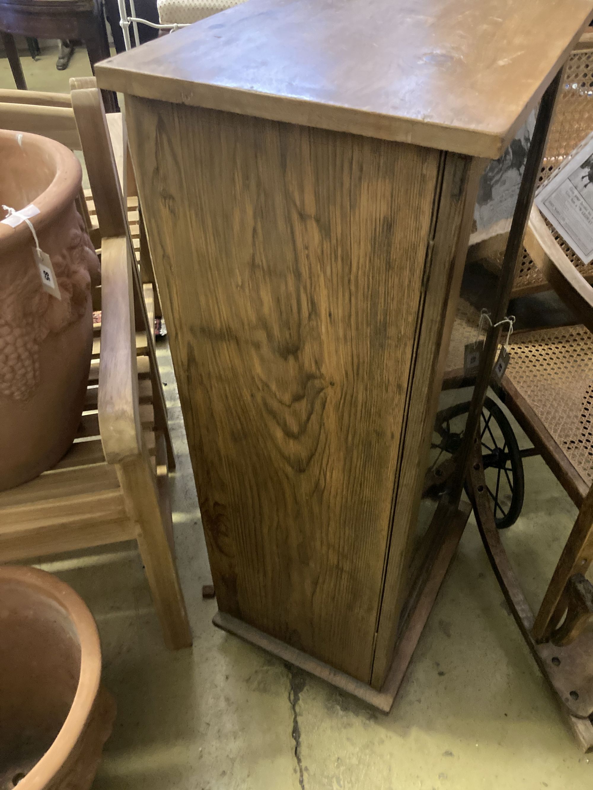 An oak and pine glazed music cabinet, glass fronted door with key, six shelves, width 52cm, depth 38cm, height 111cm